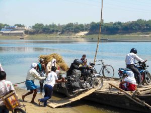 Loading Bala onto a boat to cross the Ganges